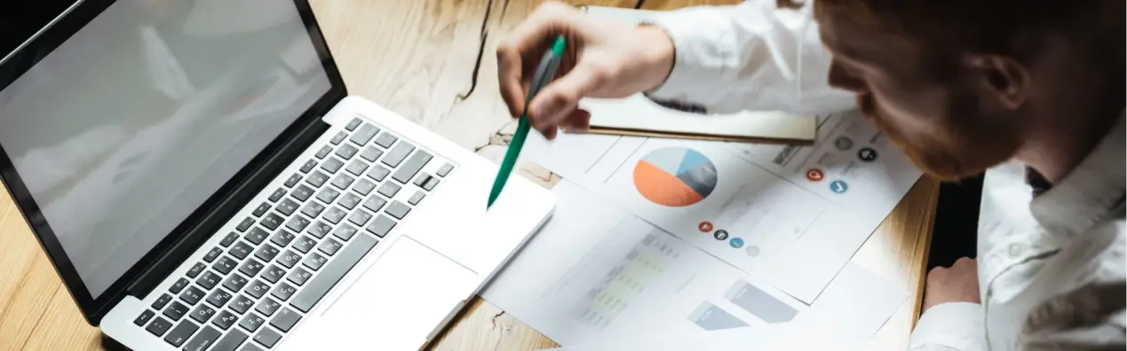 solutions-banner-top-view-young-successful-businessman-white-shirt-working-wooden-table 1